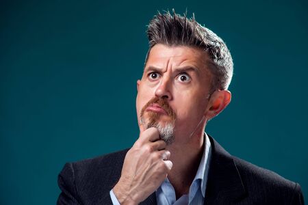 A portrait of bearded thoughtful man in suit. People and emotions conceptの写真素材