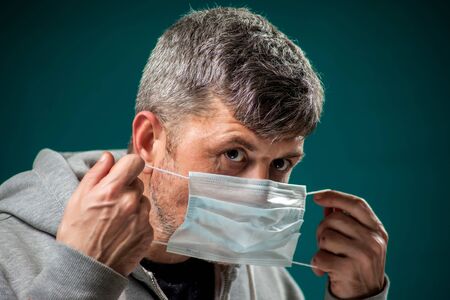 A portrait of man with medical face mask. People, medicine and healthcare concept. Coronavirus protectionの写真素材