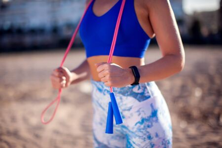 Woman training with jump rope outdoor. Close up. People, fitness and healthcare conceptの写真素材