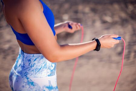Woman training with jump rope outdoor. Close up. People, fitness and healthcare conceptの写真素材
