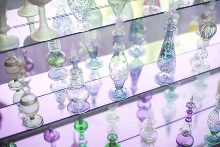 A lot of beautiful empty arabic style glass bottles for perfume in the shop behind the glass windowの写真素材