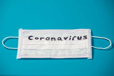 Mask with word-coronavirus on blue background. Medine and healthcare concept
