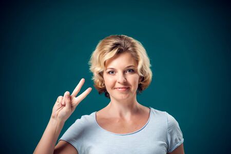 A portrait of pretty smiling woman with short blond hair looking at camera. People and emotions conceptの写真素材