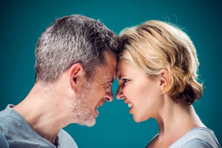 A portrait of angry couple staying face to face. People, relationships and emotions conceptの写真素材