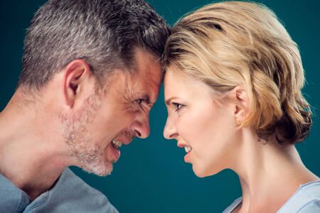 A portrait of angry couple staying face to face. People, relationships and emotions conceptの写真素材