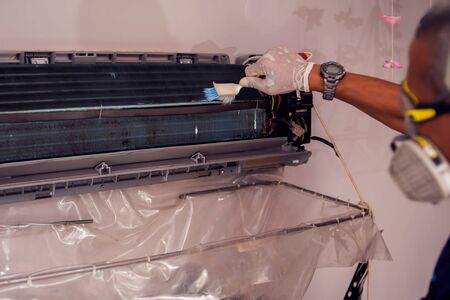 Man worker doing professional cleaning of air conditioning.の写真素材