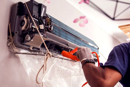 Man worker doing professional cleaning of air conditioning.の写真素材