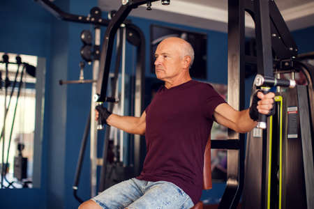 Senior man in the gym training chest muscles. People, health and lifestyle conceptの写真素材