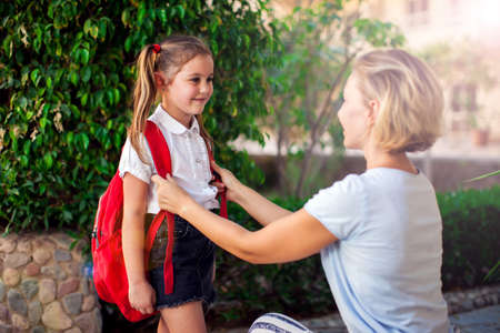 Back to school. Mother escorting her child with backpack to schoolの写真素材