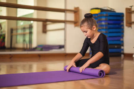 Kid girl at gymnastic class doing exercises. Children and sport conceptの写真素材