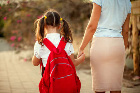 Back to school. Parent care concept. Pupil and mother going to school.