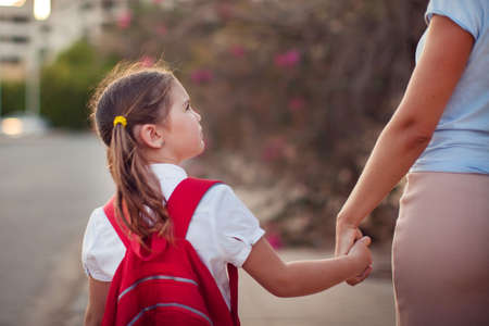 Back to school. Parent care concept. Pupil and mother going to school.の写真素材