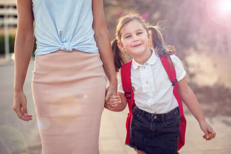Back to school. Parent care concept. Pupil and mother going to school.の写真素材