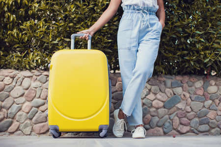 Woman with luggage outdoor. Travel, holiday and lifestyle conceptの写真素材