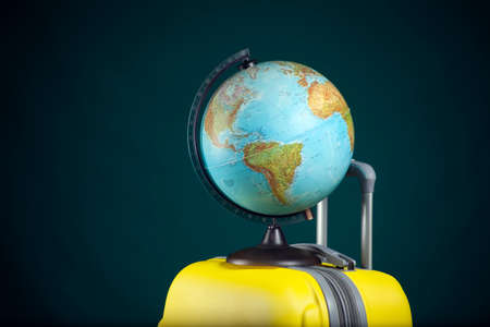 Globe on luggage. Travel and holiday concept. Studio shotの写真素材