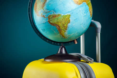 Globe on luggage. Travel and holiday concept. Studio shotの写真素材