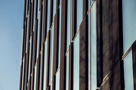 Mirrored facade building. Modern office against blue sky. Architecture concept
