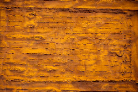 Old grunge yellow brick wall background. Brick textureの写真素材
