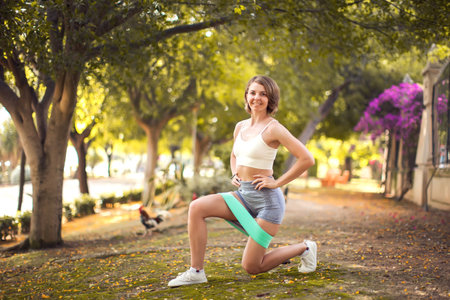 Exercise with fitness rubber bands outdoor. Woman training outdoor. Fitness and healthcare conceptの写真素材