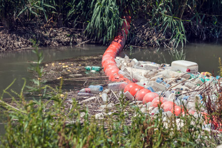 Barrier to stop floating garbage in the river. Environmental protection and ecology conceptの写真素材