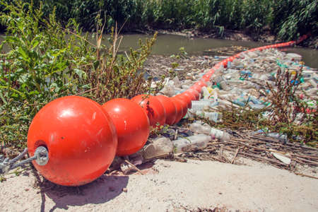 Barrier to stop floating garbage in the river. Environmental protection and ecology conceptの写真素材