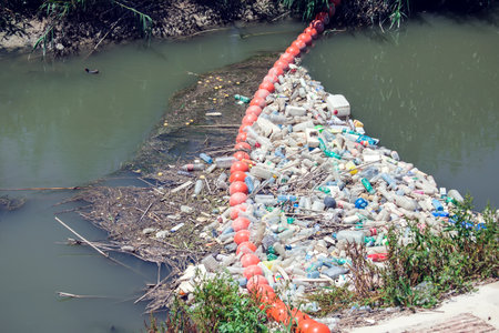 Barrier to stop floating garbage in the river. Environmental protection and ecology conceptの写真素材