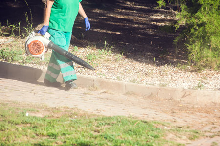 Leaf blower equipment using by worker in uniform to clean streetの写真素材