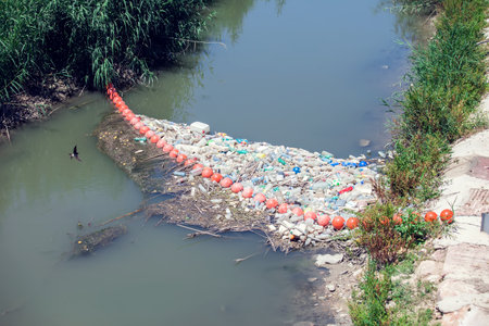 Barrier to stop floating garbage in the river. Environmental protection and ecology conceptの写真素材