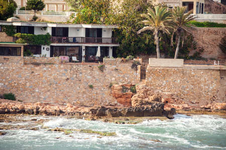 Torrevieja, Spain, 21.05.2021, landscape of rocky beach and waves at Mediterranean sea in Torreviejaの写真素材