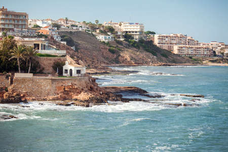 Torrevieja, Spain, 21.05.2021, landscape of rocky beach and waves at Mediterranean sea in Torrevieja, Costa Blancaの写真素材