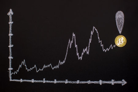 Cryptocurrency gold coin and graph on blackboard. Digital currency.の写真素材