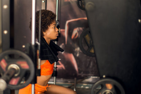 Beautiful young african american woman working out in a gymの写真素材