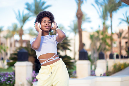 Young black girl listening to the music with headphones. Lifestyle conceptの写真素材