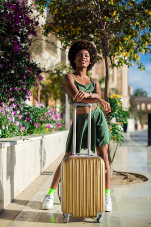 Woman tourist with suitcase luggage. Business travel, student lifestyle, people, tourism conceptの写真素材