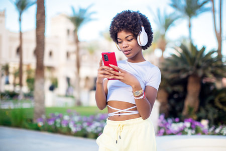 Portrait young lady out on the city street listening to music on her mobile phone. Lifestyle conceptの写真素材