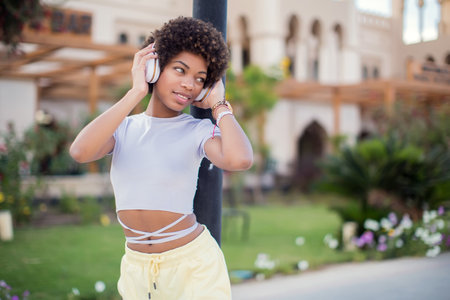Young black girl listening to the music with headphones. Lifestyle conceptの写真素材