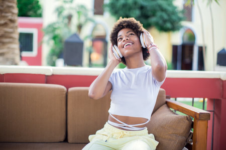 Young black girl listening to the music with headphones. Lifestyle conceptの写真素材