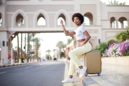 Woman tourist with suitcase luggage. Business travel, student lifestyle, people, tourism conceptの写真素材