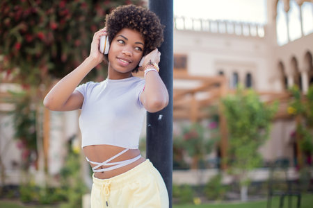 Young black girl listening to the music with headphones. Lifestyle conceptの写真素材