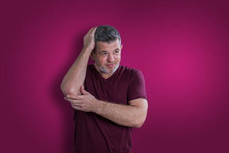 Scared and afraid man on bordo background. Fear emotion conceptの写真素材