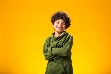 Smiling child boy over yellow background. Positive emotions conceptの写真素材