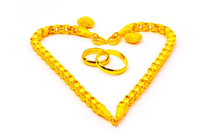 two gold rings and two gold bracelet in heart shape
