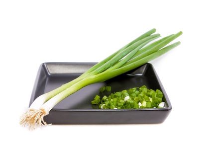 chopped green onions on white backgroundの写真素材