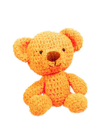 orange bear crochet doll isolated on whiteの写真素材