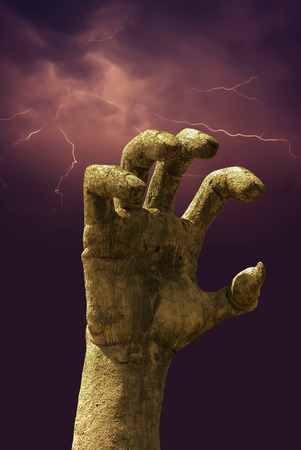 evil hand with lighting backgroundの写真素材