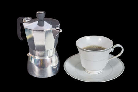 moka pot and a cup of coffee isolated on blackの写真素材