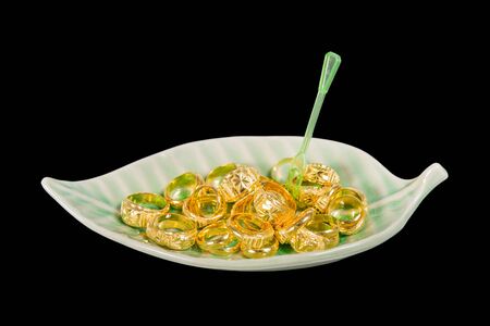golden ring look like  dessert in ceramic plate isolated on blackの写真素材