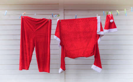 Santa Claus prepares his outfit in time for Christmas.  Clothes of Santa Claus.