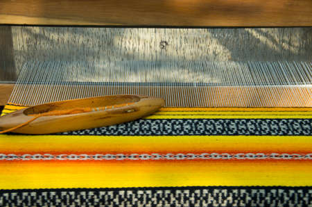 Crafts. Hand loom with many colorful woolen threads.
