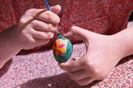 Child decorate an Easter egg.の写真素材